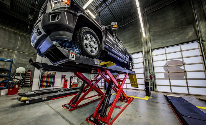 Commercial photoshoot of a Tire Shop showing a truck on a lift