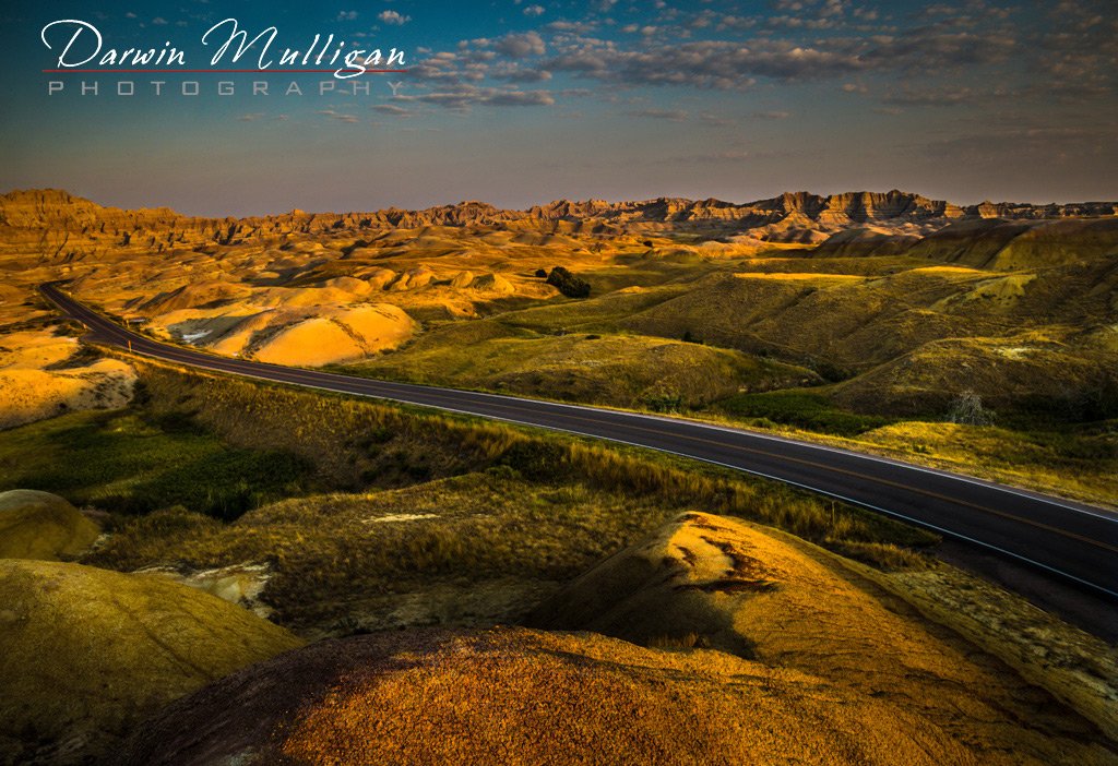 Early-morning-photo-of-highway-going-through-Badlands-National-Park-South-Dakota