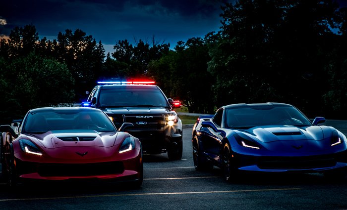 Set up photo with 2 Corvettes and Police