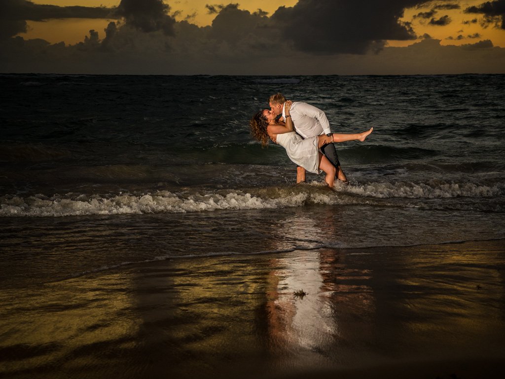 Sunrise kiss in the ocean for Trash the Wedding Dress. Destination wedding at Punta Cana, Dominican Republic